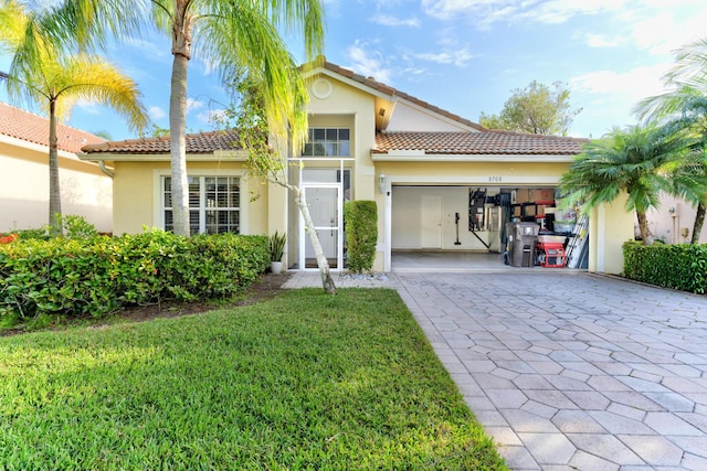 mediterranean / spanish-style house featuring a front lawn