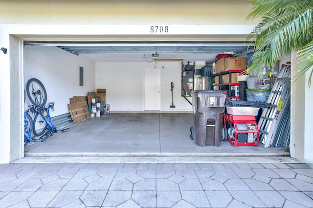 garage with a garage door opener and electric panel