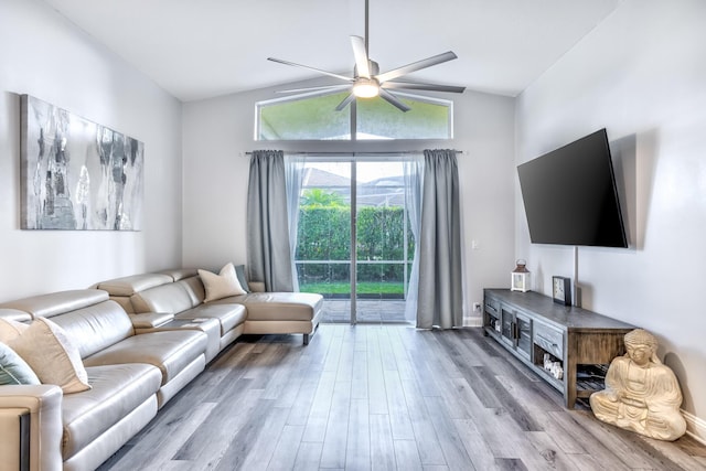 living room with vaulted ceiling, ceiling fan, and light hardwood / wood-style floors