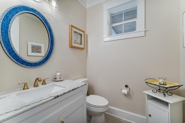 bathroom with crown molding, vanity, toilet, and hardwood / wood-style flooring