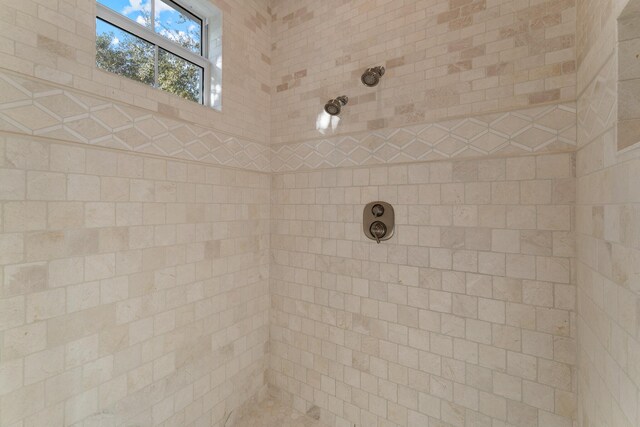 bathroom featuring vanity, a bath, and tile walls