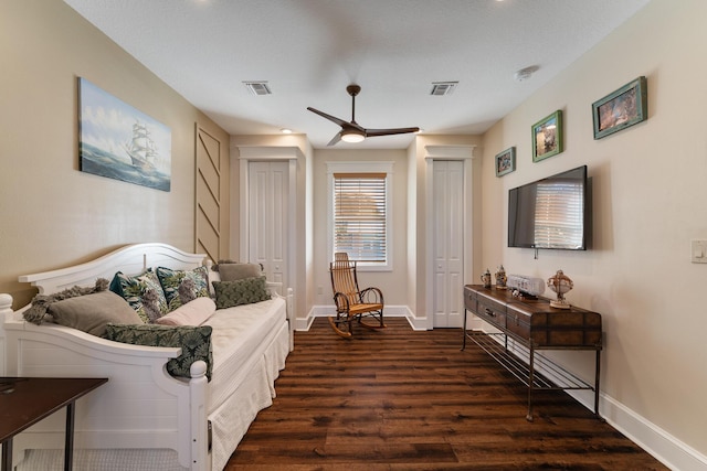 interior space featuring ceiling fan, dark wood finished floors, visible vents, and baseboards