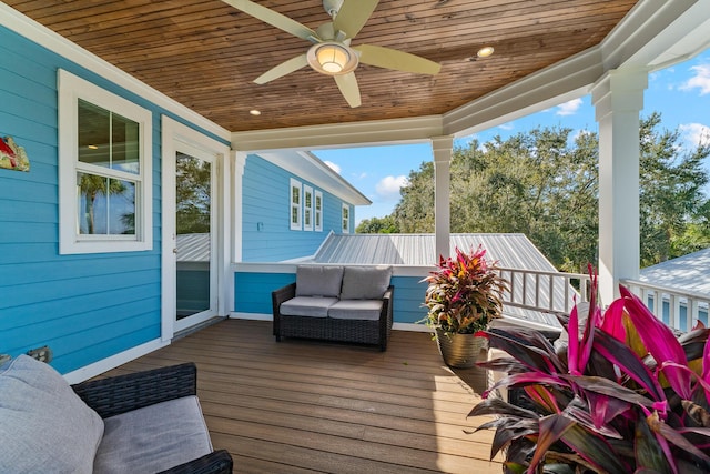 wooden terrace featuring an outdoor living space and a ceiling fan