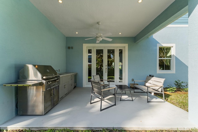 view of patio featuring french doors, grilling area, exterior kitchen, and a ceiling fan