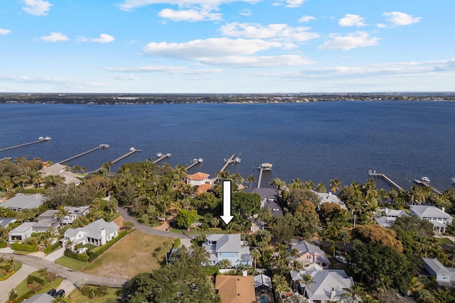 drone / aerial view featuring a residential view and a water view