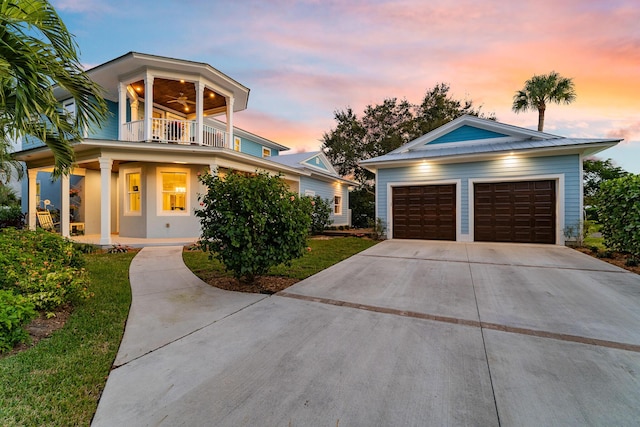 view of front of home with a porch, a balcony, and a garage