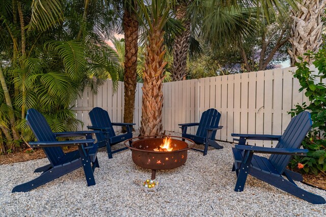 yard at dusk featuring a fire pit