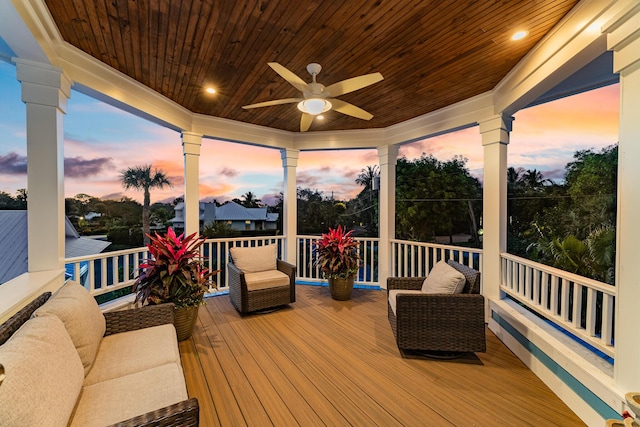 wooden terrace featuring outdoor lounge area and a ceiling fan