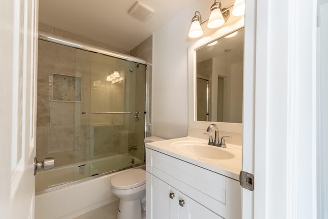 full bathroom with vanity, combined bath / shower with glass door, and toilet