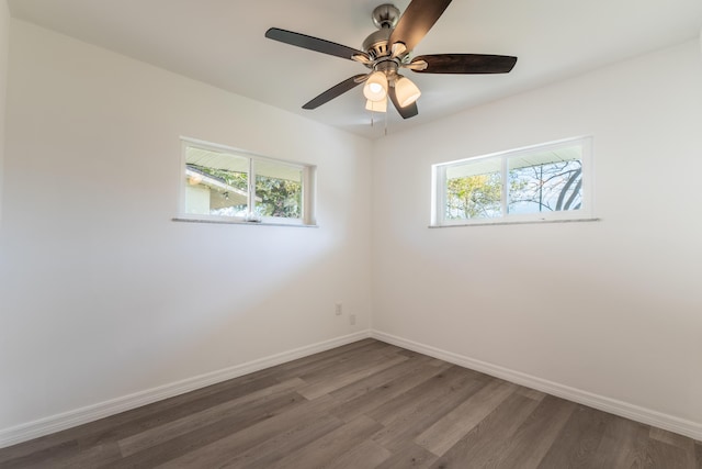 unfurnished room featuring ceiling fan, a healthy amount of sunlight, and dark hardwood / wood-style flooring