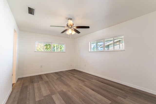 unfurnished room with ceiling fan and dark hardwood / wood-style flooring