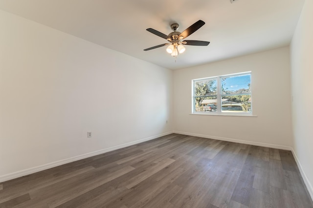 empty room featuring dark wood-type flooring and ceiling fan