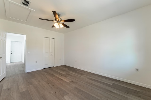 unfurnished bedroom with hardwood / wood-style flooring, a closet, and ceiling fan