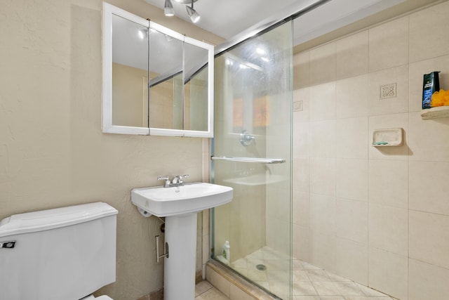 bathroom with toilet, sink, and walk in shower