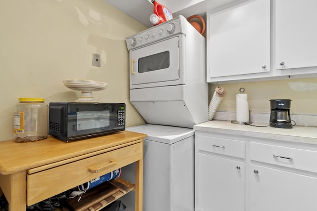 laundry room featuring stacked washer / drying machine