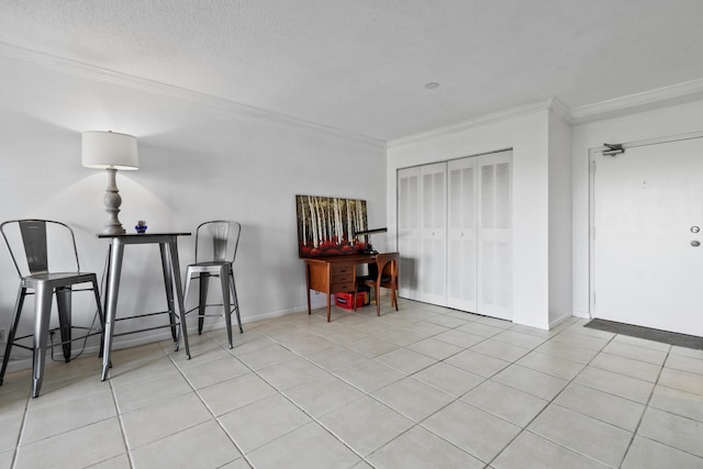 interior space featuring crown molding, a textured ceiling, and light tile patterned floors