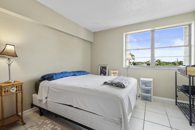 tiled bedroom with a textured ceiling