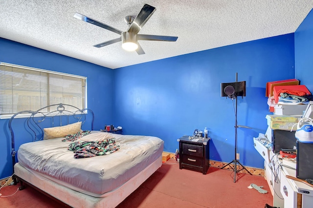 carpeted bedroom with ceiling fan and a textured ceiling