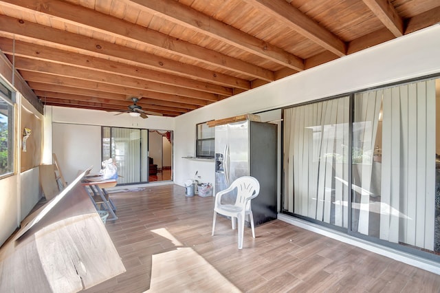 sunroom / solarium featuring beam ceiling, wood ceiling, a wealth of natural light, and ceiling fan