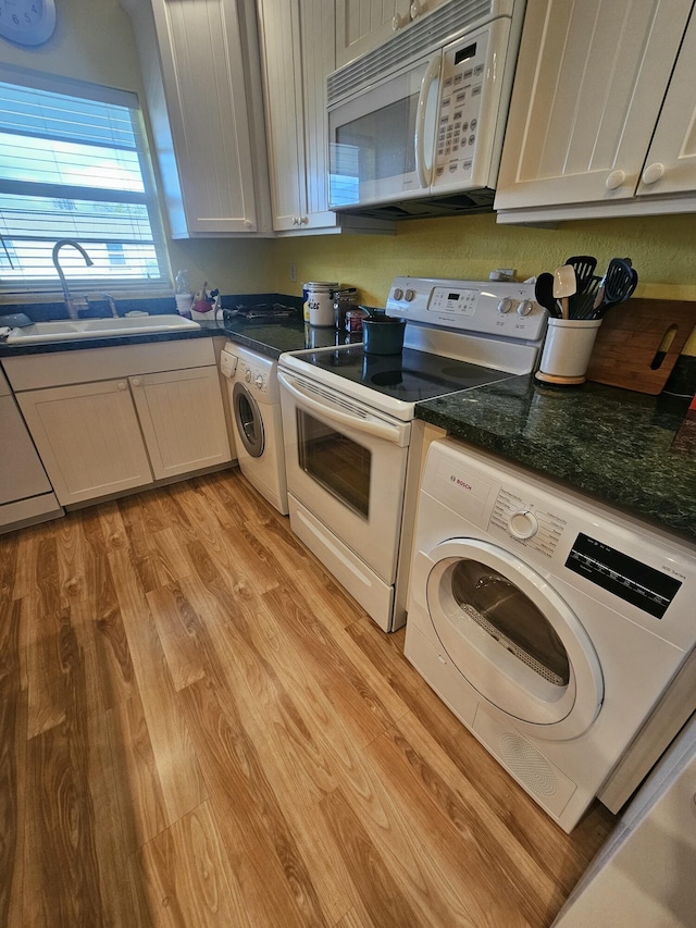 washroom featuring washer / dryer, sink, and light hardwood / wood-style flooring