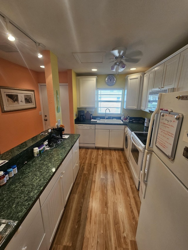 kitchen featuring white cabinetry, sink, white appliances, and light wood-type flooring