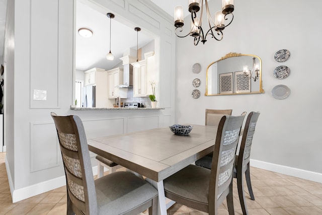 tiled dining area featuring a chandelier