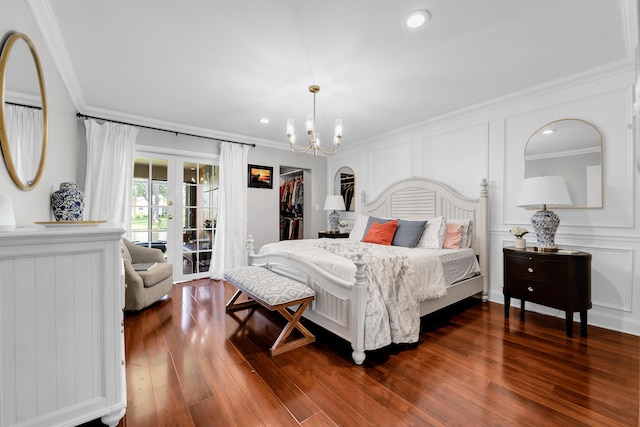 bedroom featuring crown molding, dark wood-type flooring, access to exterior, french doors, and a chandelier