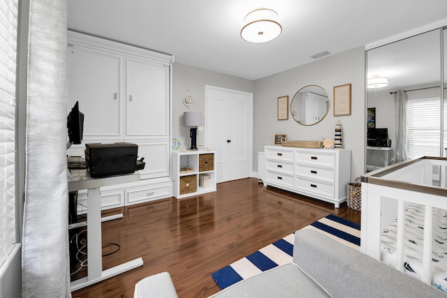 bedroom with dark hardwood / wood-style flooring