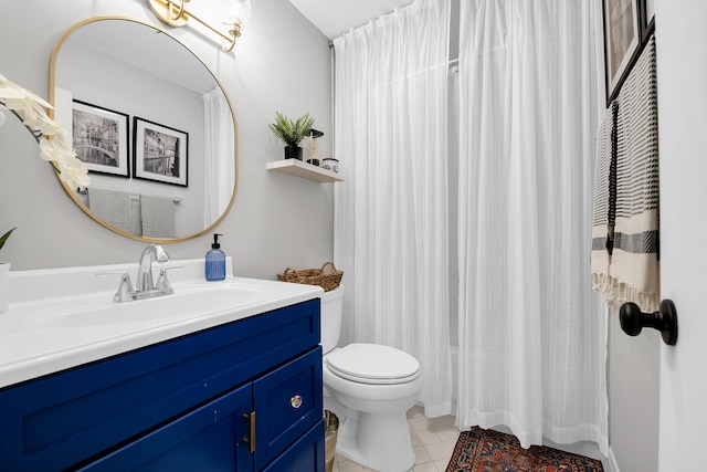 bathroom featuring tile patterned flooring, vanity, and toilet