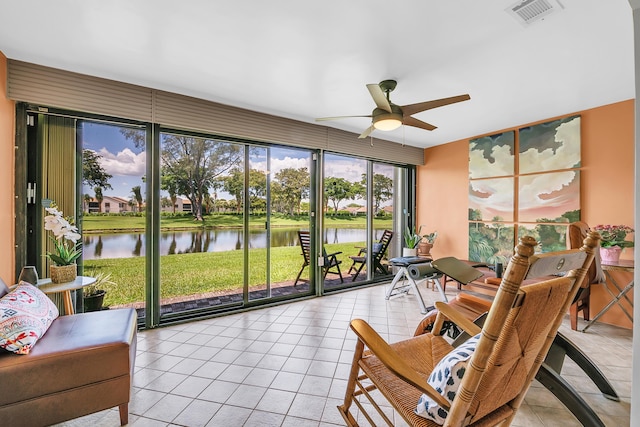 sunroom / solarium with a water view and ceiling fan