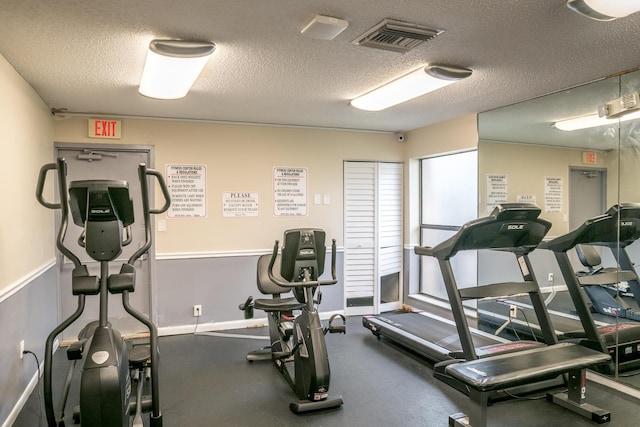 gym featuring a textured ceiling