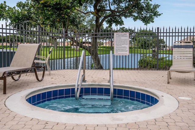 view of swimming pool featuring a water view