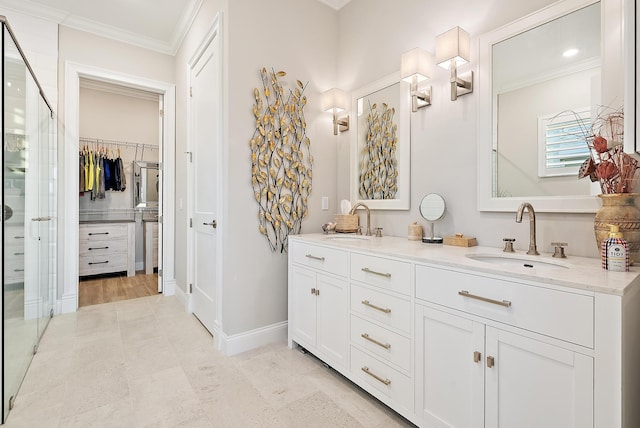 bathroom featuring ornamental molding, a stall shower, a sink, and double vanity