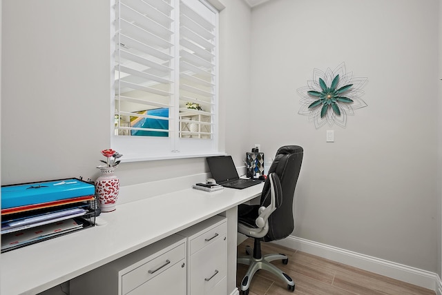 office featuring light wood-style flooring and baseboards