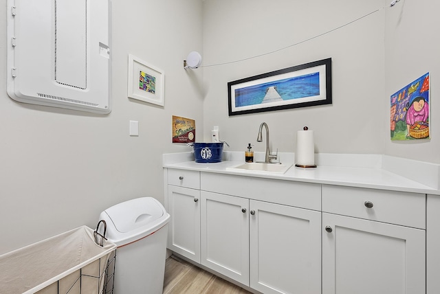 bathroom featuring toilet, wood finished floors, and vanity