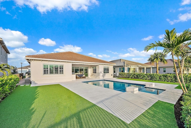 view of swimming pool featuring a patio area, a lawn, fence, and a fenced in pool