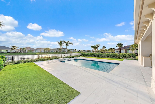 view of pool with a yard, a patio, a water view, a residential view, and a fenced backyard