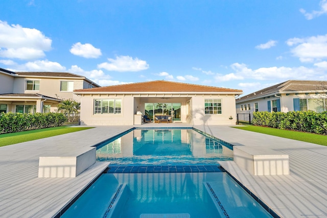 view of pool featuring an outdoor living space, a patio area, fence, and a pool with connected hot tub