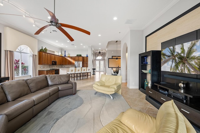 living room featuring ornamental molding, light tile patterned floors, and ceiling fan