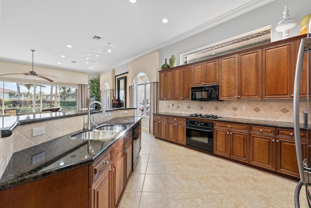 kitchen with sink, crown molding, tasteful backsplash, dark stone countertops, and black appliances