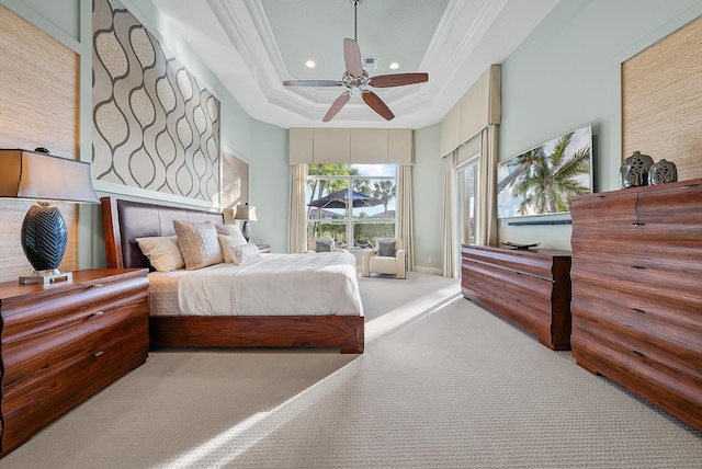 bedroom with a raised ceiling, crown molding, light carpet, and ceiling fan