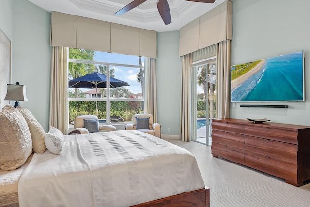 bedroom with crown molding, ceiling fan, access to exterior, and a high ceiling