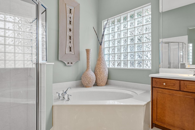 bathroom with vanity and separate shower and tub