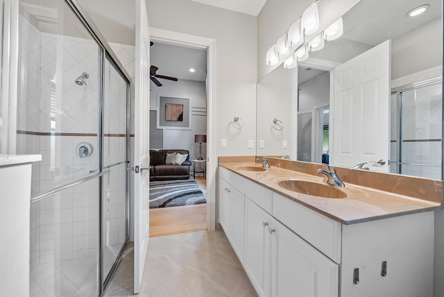 bathroom with vanity, a shower with door, tile patterned floors, and ceiling fan