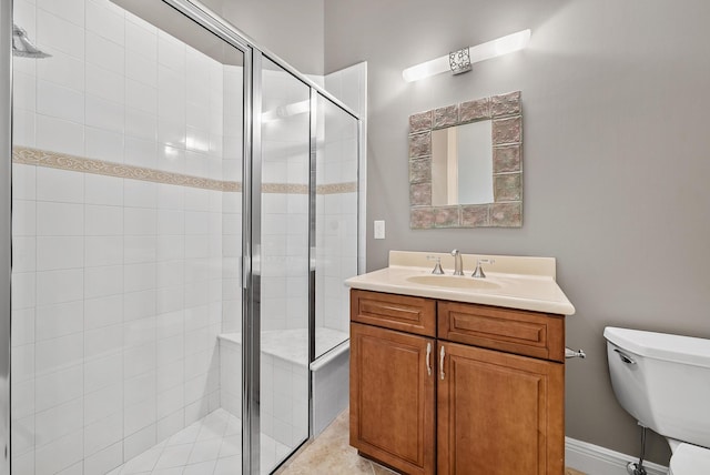 bathroom featuring an enclosed shower, vanity, and toilet