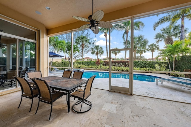 view of pool with ceiling fan and a patio area