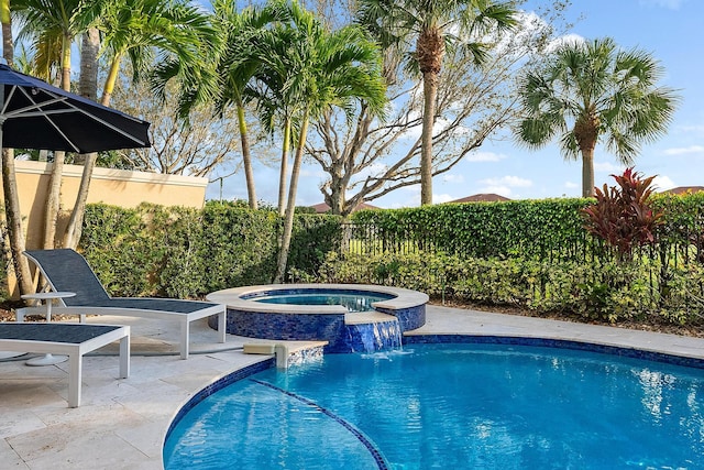 view of pool with an in ground hot tub, pool water feature, and a patio area