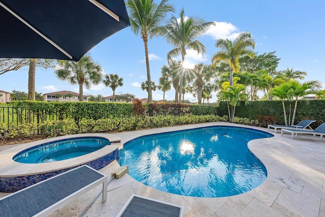 view of swimming pool with an in ground hot tub and a patio area