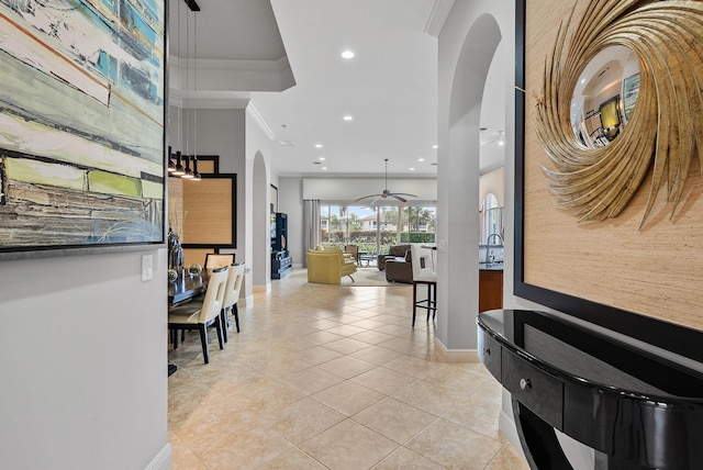 hallway with crown molding and light tile patterned floors