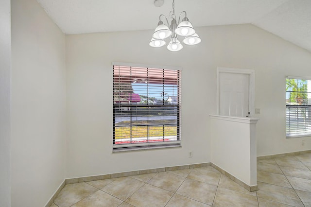 unfurnished dining area featuring an inviting chandelier, light tile patterned floors, and vaulted ceiling